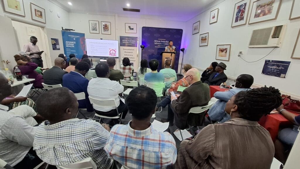 Attendees networking and engaging at the African Australian Advocacy Centre's End of Year Gathering and Annual General Meeting, highlighting discussions and collaborations.