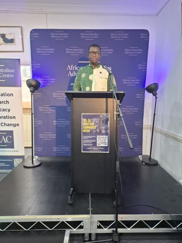 Keynote speaker Noel Zihabamwe and community leaders speaking at the African Australian Advocacy Centre's End of Year Gathering and Annual General Meeting.